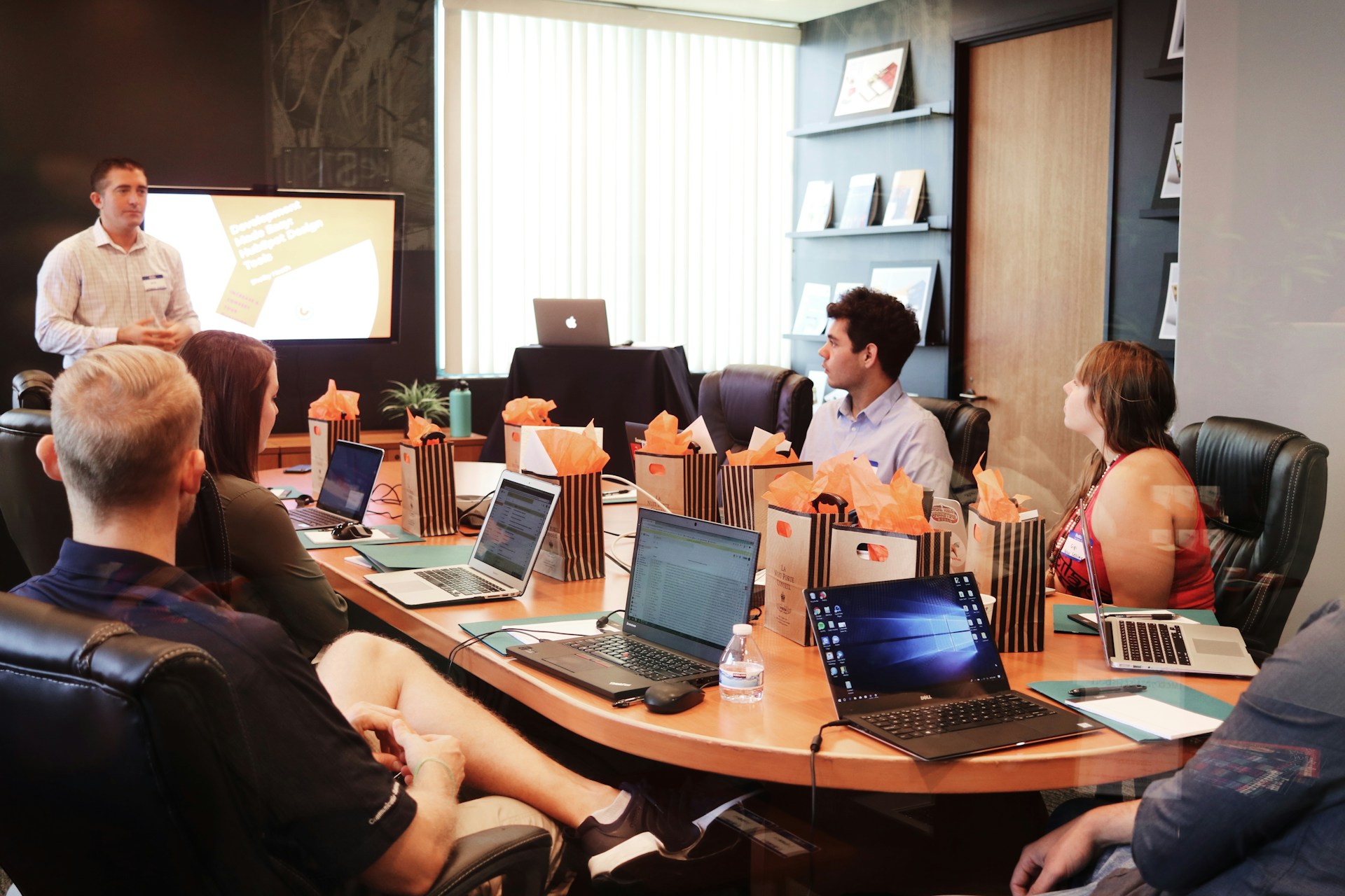 Team of marketing professionals strategizing around a whiteboard"