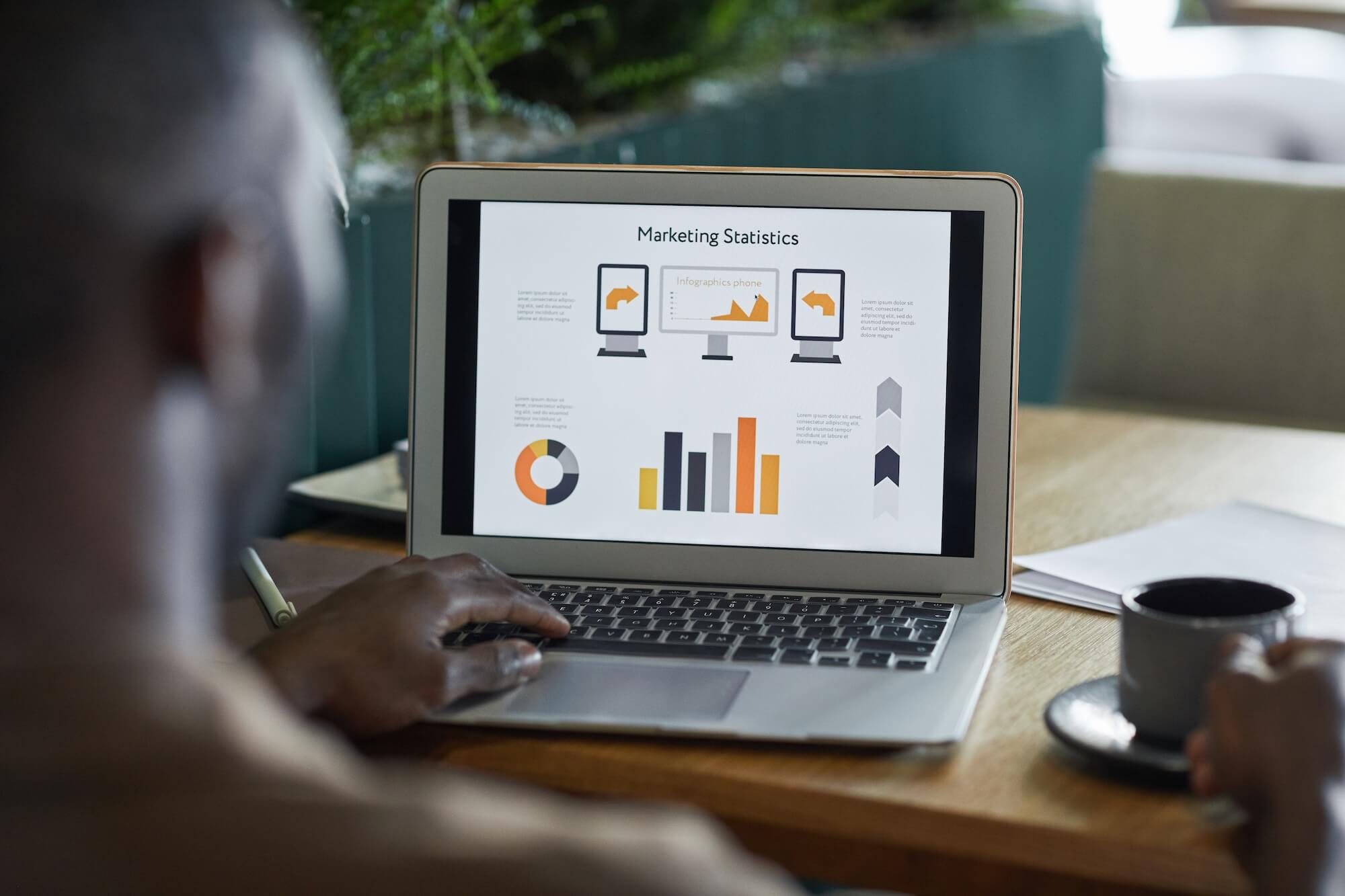 A person viewing marketing analytics on a laptop.